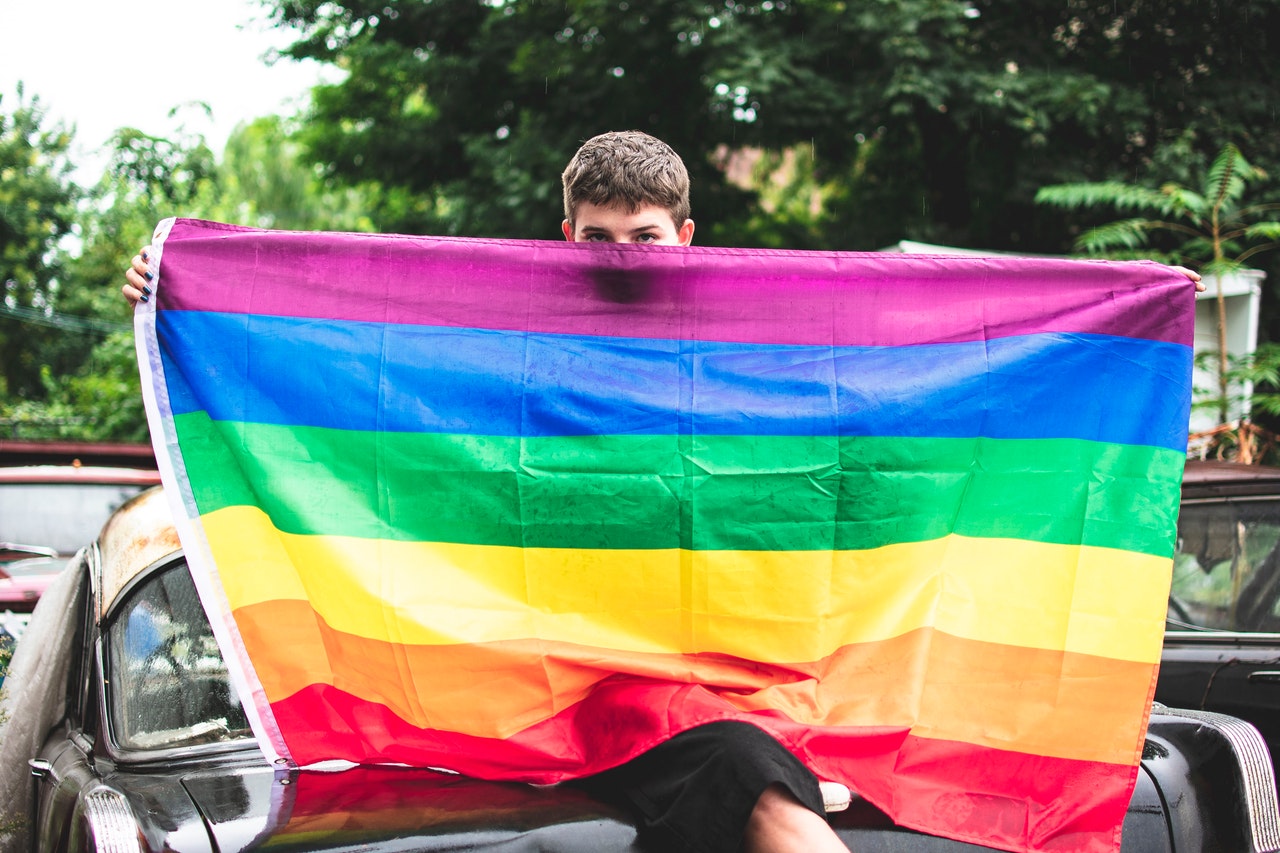 Boy Holding Rainbow Flag