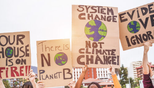 group-of-demonstrators-on-road-young-people-from-different-culture-and-race-fight-for-climate-change-global-warming-and-enviroment-concept-focus-on-banners